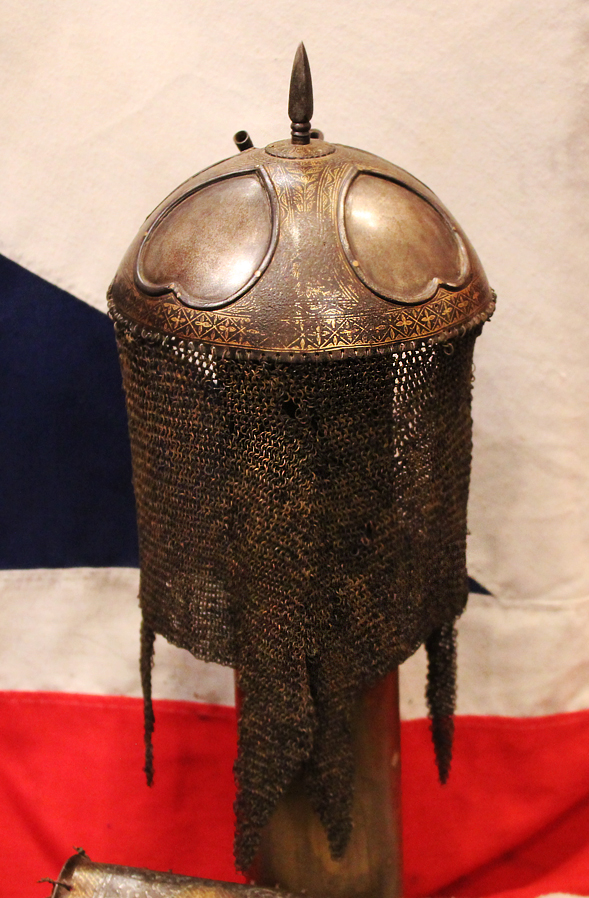 A Gold Inlaid Traditional Persian Armour Suite, of Helmet, Shield & Arm Defence. The Kulah Khud,(کلاهخود) Sipar (سپر), and Bazu Band (بازوبند). Late 18th to Early 19th Century, Possibly Wootz Steel { Pulad}
