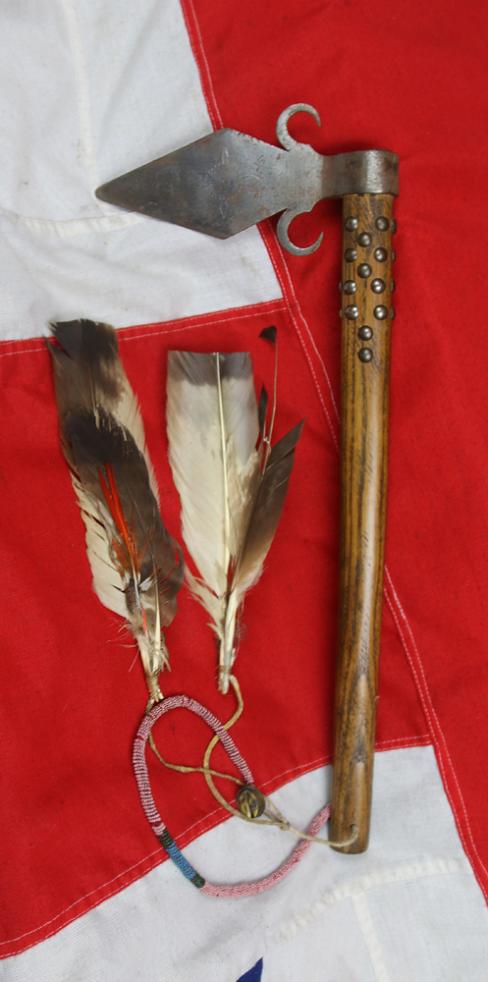 A Superbly Attractive, Native American Indian 'Spontoon Head' Style Tomahawk with Studded Haft, Glass Beads, and Eagle Feathers.