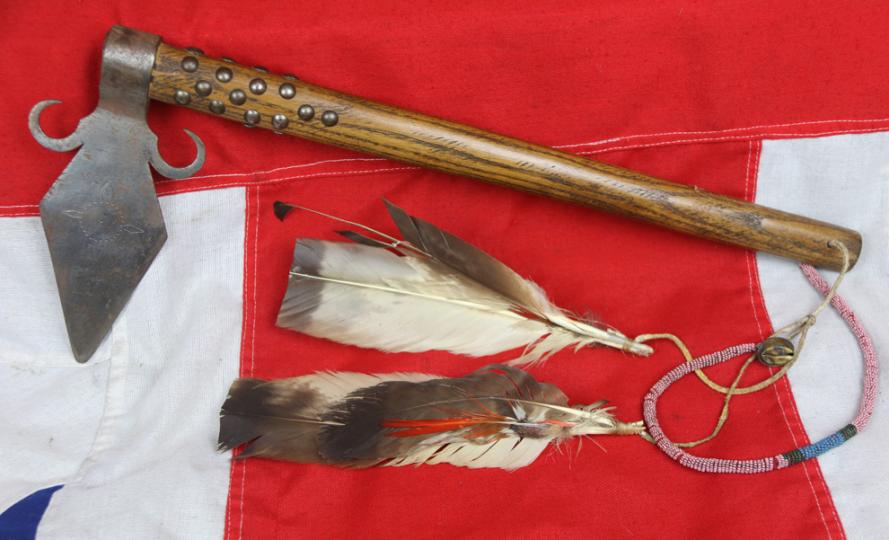 A Superbly Attractive, Native American Indian 'Spontoon Head' Style Tomahawk with Studded Haft, Glass Beads, and Eagle Feathers.