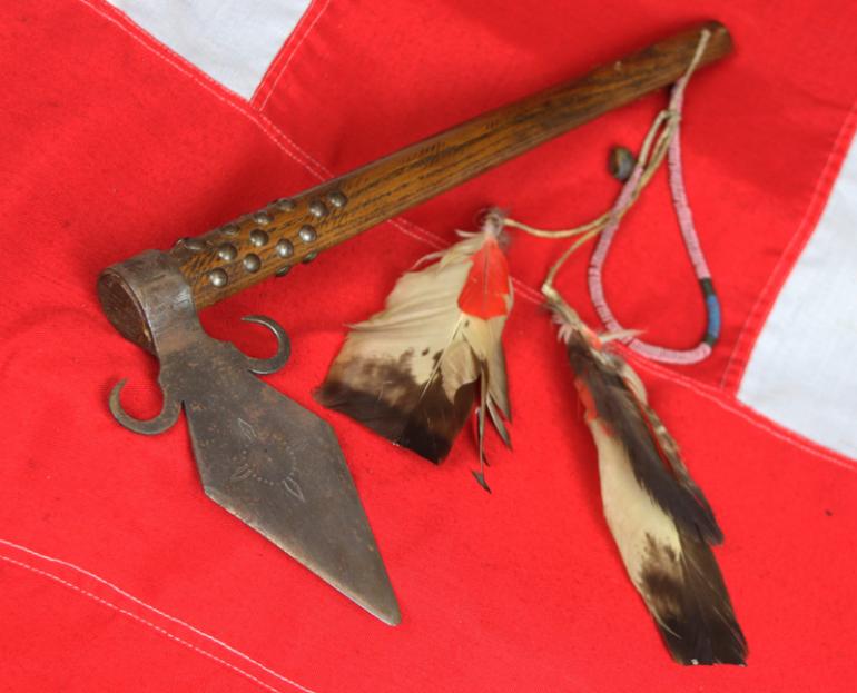 A Superbly Attractive, Native American Indian 'Spontoon Head' Style Tomahawk with Studded Haft, Glass Beads, and Eagle Feathers.