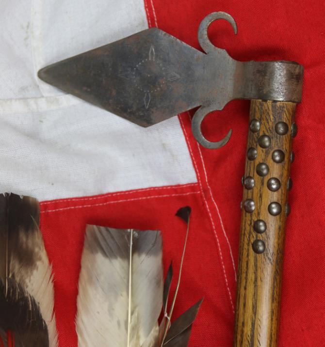 A Superbly Attractive, Native American Indian 'Spontoon Head' Style Tomahawk with Studded Haft, Glass Beads, and Eagle Feathers.