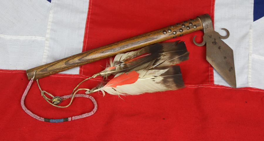 A Superbly Attractive, Native American Indian 'Spontoon Head' Style Tomahawk with Studded Haft, Glass Beads, and Eagle Feathers.
