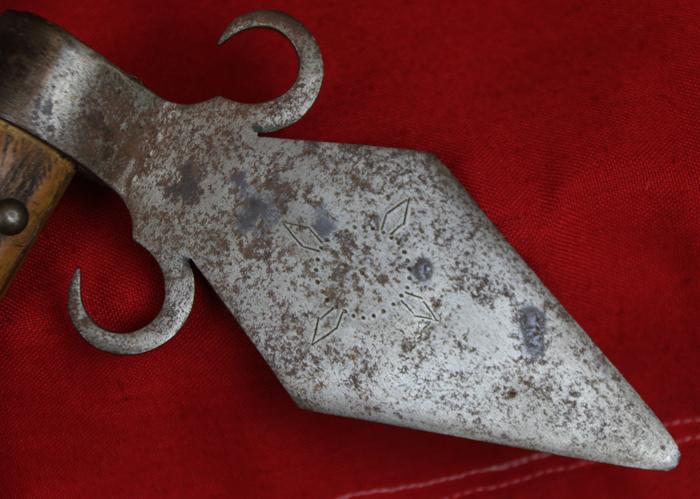 A Superbly Attractive, Native American Indian 'Spontoon Head' Style Tomahawk with Studded Haft, Glass Beads, and Eagle Feathers.