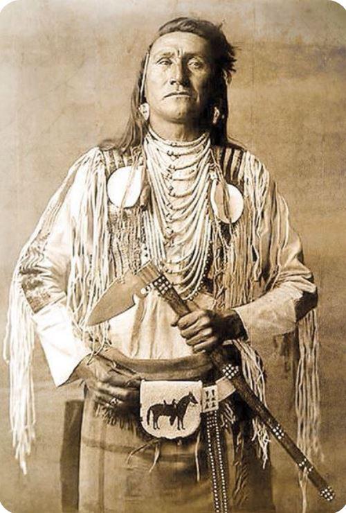 A Superbly Attractive, Native American Indian 'Spontoon Head' Style Tomahawk with Studded Haft, Glass Beads, and Eagle Feathers.