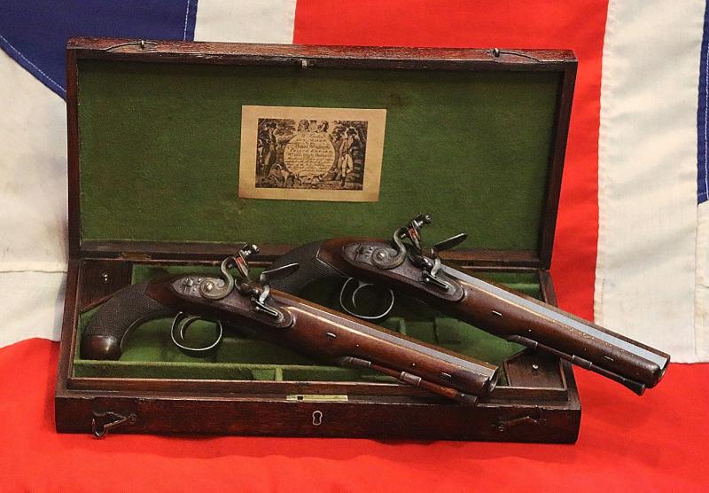 A Very Fine Condition Classic, Cased Pair of Late 18th to Early 19th Century Damascus Barrelled Duelling Pistols by Master Gunsmith William Parker of Holborn London. Original Oak Case with Tools and Accessories