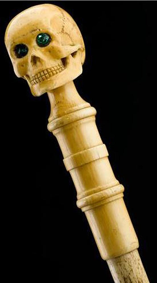 An Imposing & Elegant ‘Morituri’ Walking Cane Combination ‘Bartitsu’ Club Stick, Cast Bronze Skull With & Sophisticated Ebony Stick & Carved Bone Ferrul. Once A Most Essential Accessory For the Gentleman About Town.