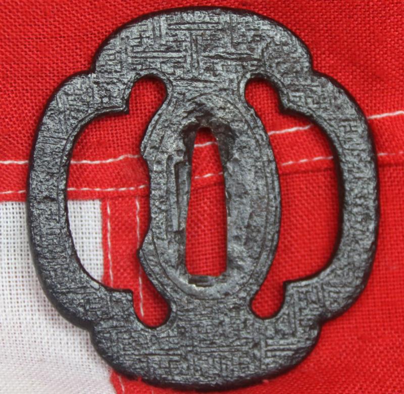 An Edo Period Iron Mokko Form Tsuba Engraved with Geometric Manji Design