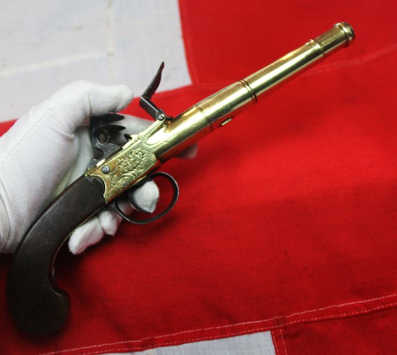 A Stunning Mid 18th Century Ship's Captain Brass Cannon Barrel Pistol with a Silver Escutchon of the Goddess Minerva Adorned With Her Dolphin Helmet & Fishscale Armour