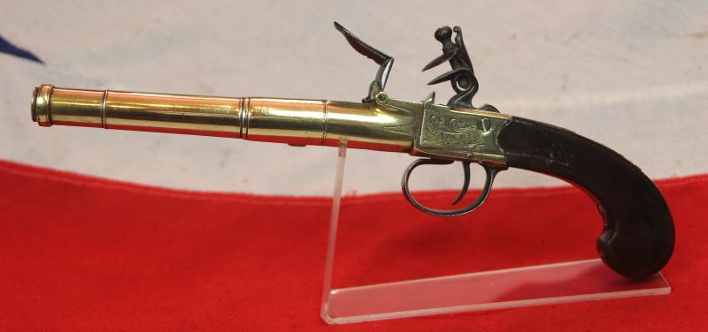 A Stunning Mid 18th Century Ship's Captain Brass Cannon Barrel Pistol with a Silver Escutchon of the Goddess Minerva Adorned With Her Dolphin Helmet & Fishscale Armour