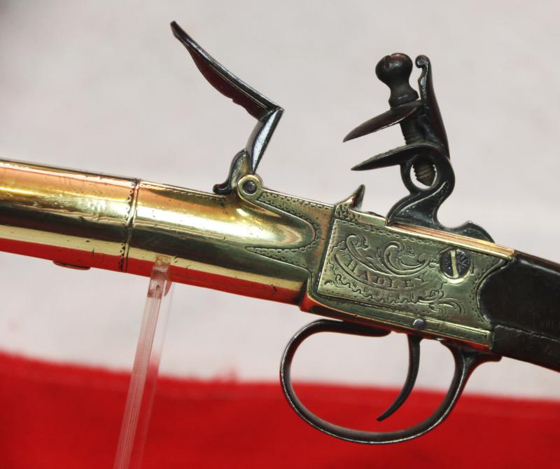 A Stunning Mid 18th Century Ship's Captain Brass Cannon Barrel Pistol with a Silver Escutchon of the Goddess Minerva Adorned With Her Dolphin Helmet & Fishscale Armour