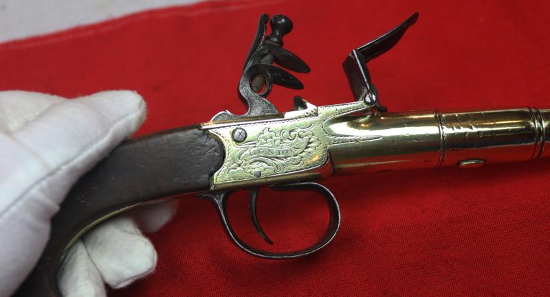 A Stunning Mid 18th Century Ship's Captain Brass Cannon Barrel Pistol with a Silver Escutchon of the Goddess Minerva Adorned With Her Dolphin Helmet & Fishscale Armour