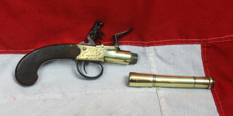 A Stunning Mid 18th Century Ship's Captain Brass Cannon Barrel Pistol with a Silver Escutchon of the Goddess Minerva Adorned With Her Dolphin Helmet & Fishscale Armour