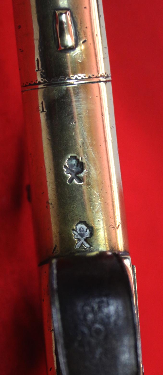 A Stunning Mid 18th Century Ship's Captain Brass Cannon Barrel Pistol with a Silver Escutchon of the Goddess Minerva Adorned With Her Dolphin Helmet & Fishscale Armour