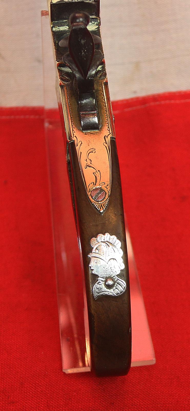 A Stunning Mid 18th Century Ship's Captain Brass Cannon Barrel Pistol with a Silver Escutchon of the Goddess Minerva Adorned With Her Dolphin Helmet & Fishscale Armour