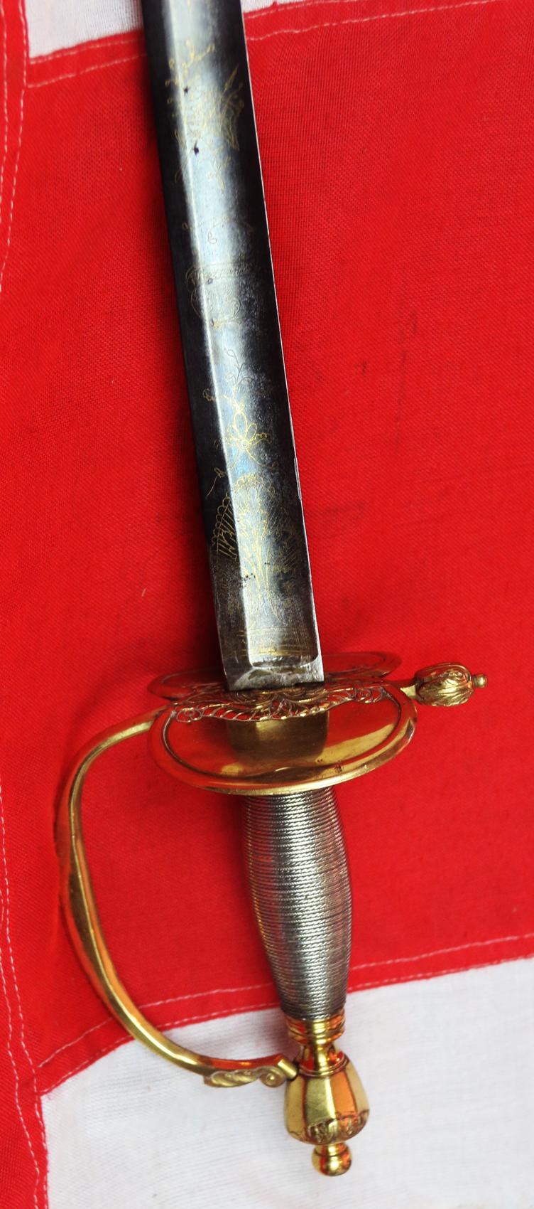 A Very Good 1796 Pattern Infantry Officer's Sword, Beautiful Gilt and Solid Silver Grip. Stunningly Hand Engraved with Royal Crest, Crowned Cyphers And A Standing Infantry Officer Holding His 1796 infantry Sword.