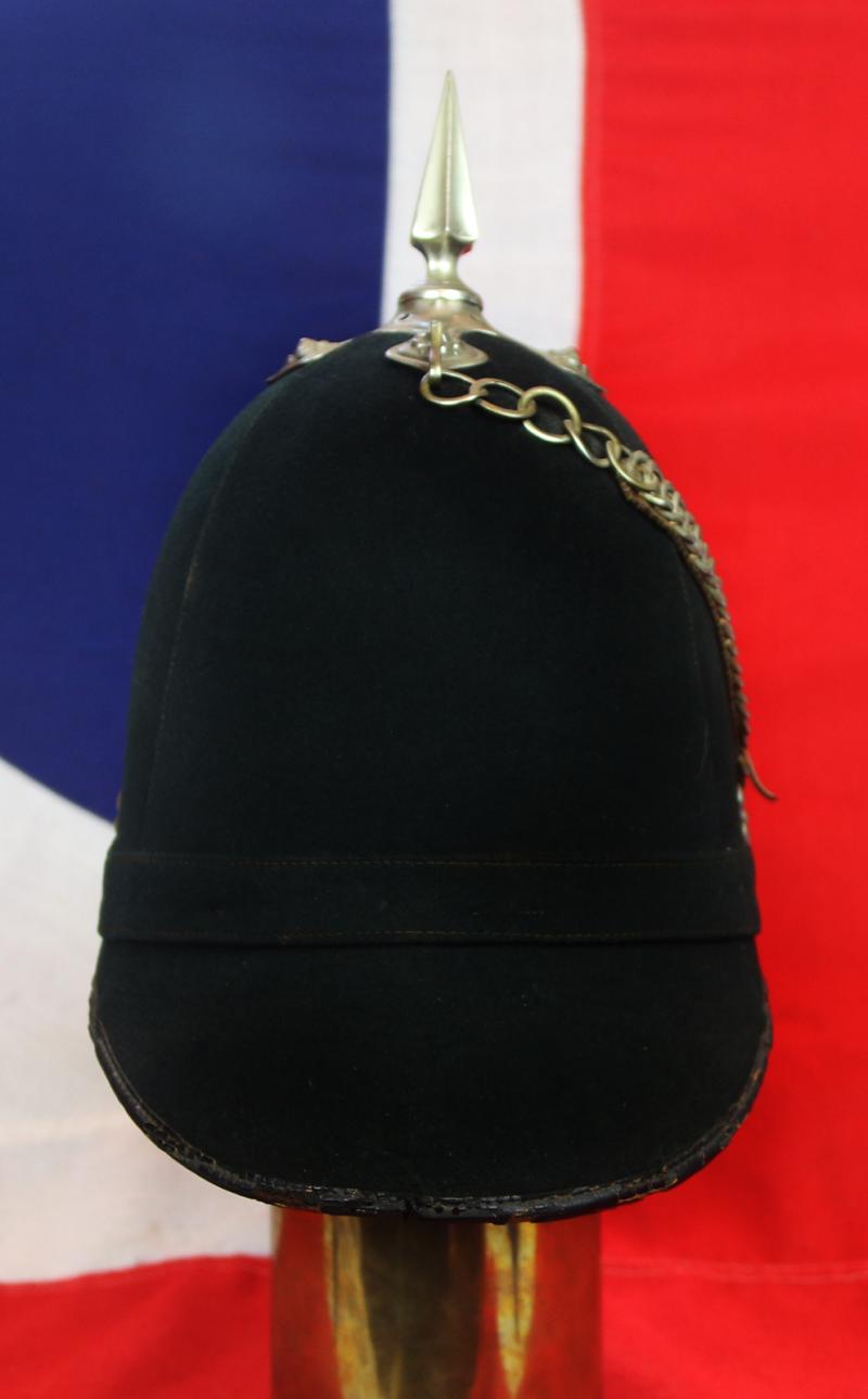 A Superb Victorian Service Helmet of the Hampshire Regiment, the Ist Volunteer Battalion. Blue Cloth with Silver Badge, Fittings, Spike, & Rose Head Curb Chain Mounts and Chin Chain