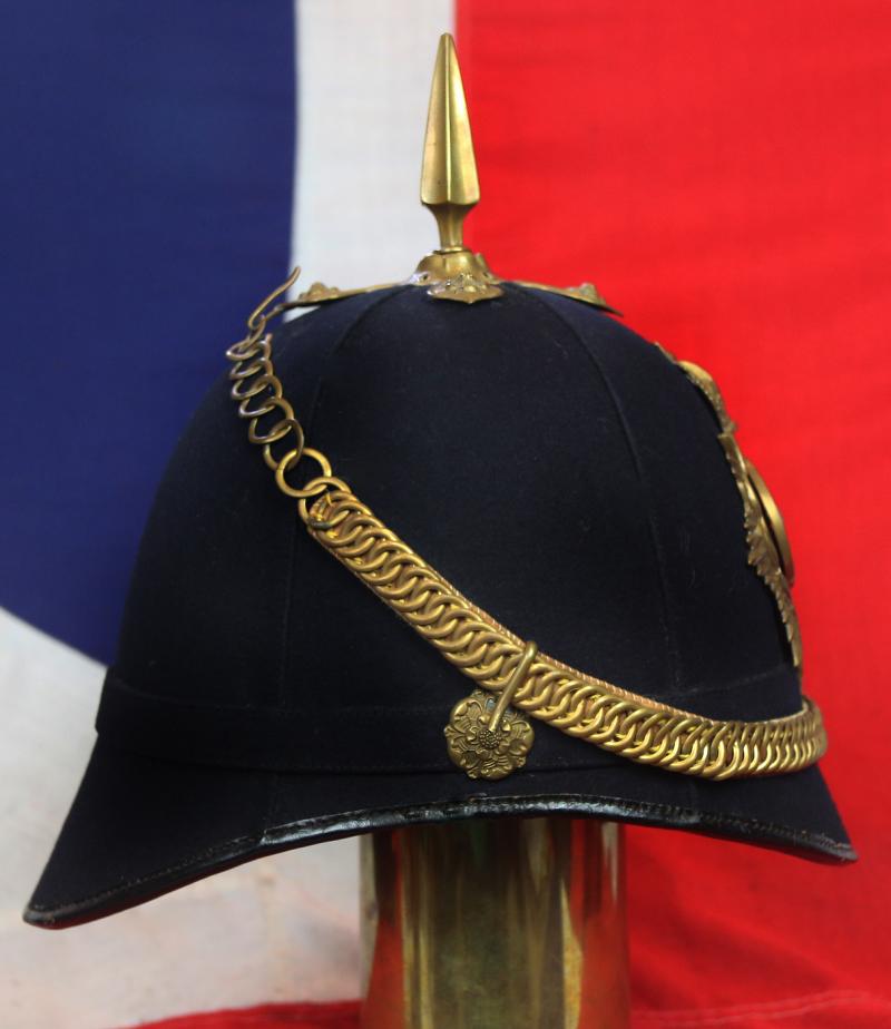 A Superb British, Original, Regimental Edwardian Service Helmet. of The West Yorkshire Regiment. Blue Cloth with Gold Badge, Fittings, Spike, & Rose Head Curb Chain Mounts and Chin Chain