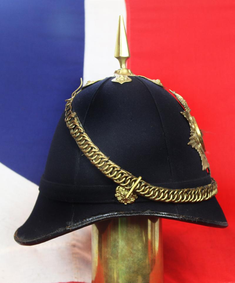A Superb Antique Edwardian Service Helmet of The Dorsetshire Regiment. Blue Cloth with Gold Badge, Fittings, Spike, & Rose Head Curb Chain Mounts and Chin Chain