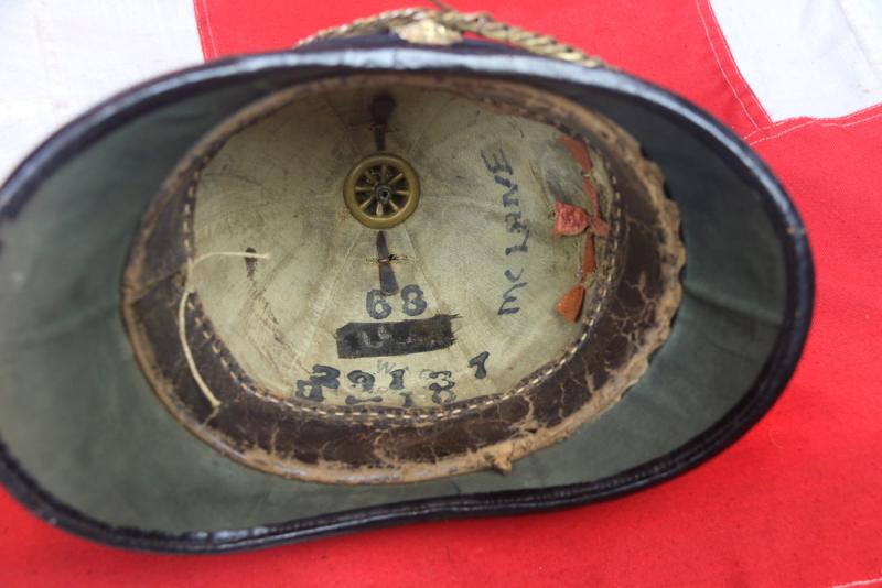 A Superb Antique Edwardian Service Helmet of The Dorsetshire Regiment. Blue Cloth with Gold Badge, Fittings, Spike, & Rose Head Curb Chain Mounts and Chin Chain