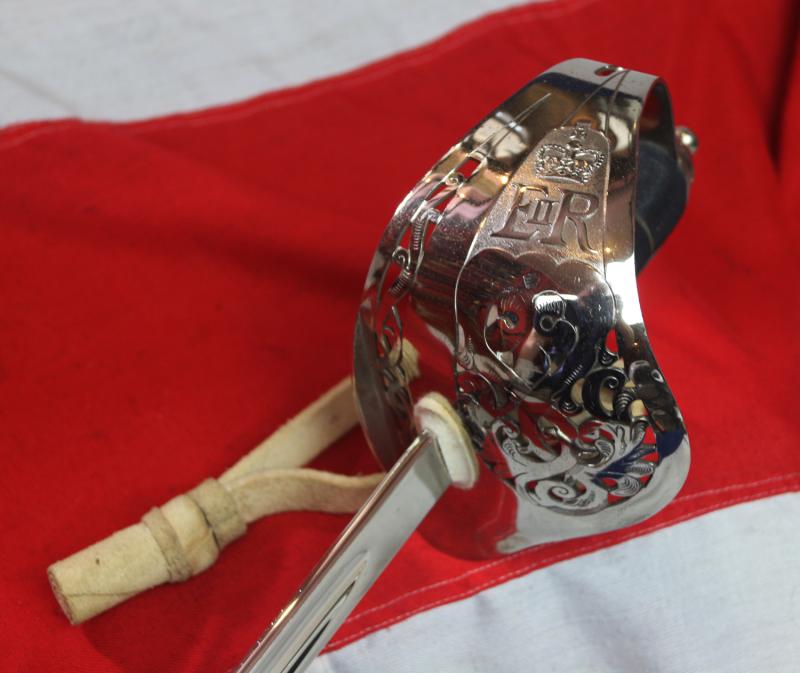 A Very Good Current Service 1897 Pattern ERII Post 1953 Officer's Sword In Nickel Plated Dress Scabbard, with Its Original Buff Hide Knot