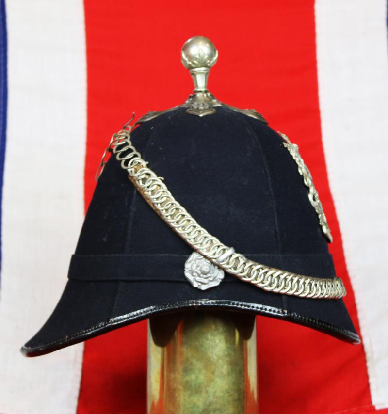 A Beautiful, Victorian, Scottish Artillery Service Helmet of the First Renfrew and Dumbarton Artillery. Blue Cloth with Silver Badge, Fittings, Ball Top, & Rose Head Curb Chain Mounts and Chin Chain