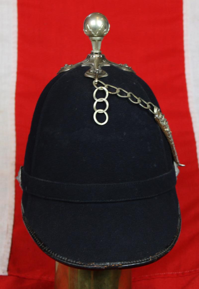 A Beautiful, Victorian, Scottish Artillery Service Helmet of the First Renfrew and Dumbarton Artillery. Blue Cloth with Silver Badge, Fittings, Ball Top, & Rose Head Curb Chain Mounts and Chin Chain