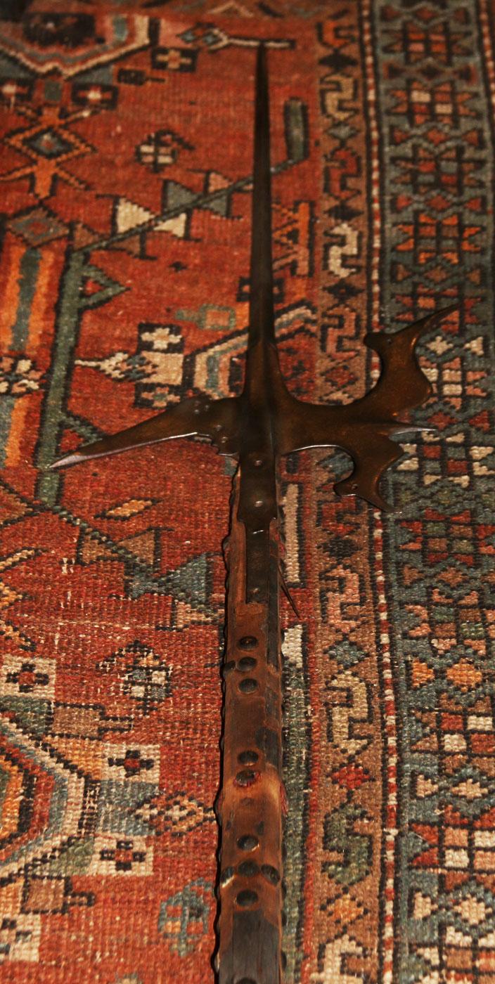 A Superb 16th Century Tudor Era Gothic Renaissance Halberd, Queen Elizabeth Ist Period. Traditional Iron Head With Tall Central Spike With A Twin Bird's-Head Axe Blade & Sharp Flat Hook Counter Blade. With Original 7ft Studded Haft