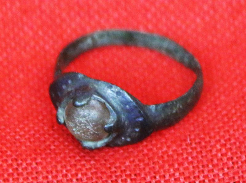 A Wonderful, Around 1200 Year Old Original Viking Bronze Ring, Four Claw Bezel Setting With Its Original Amber Glass Cabochon Gem. Punched Dot Decor Around The Ovoid Surround Of The Claw Setting